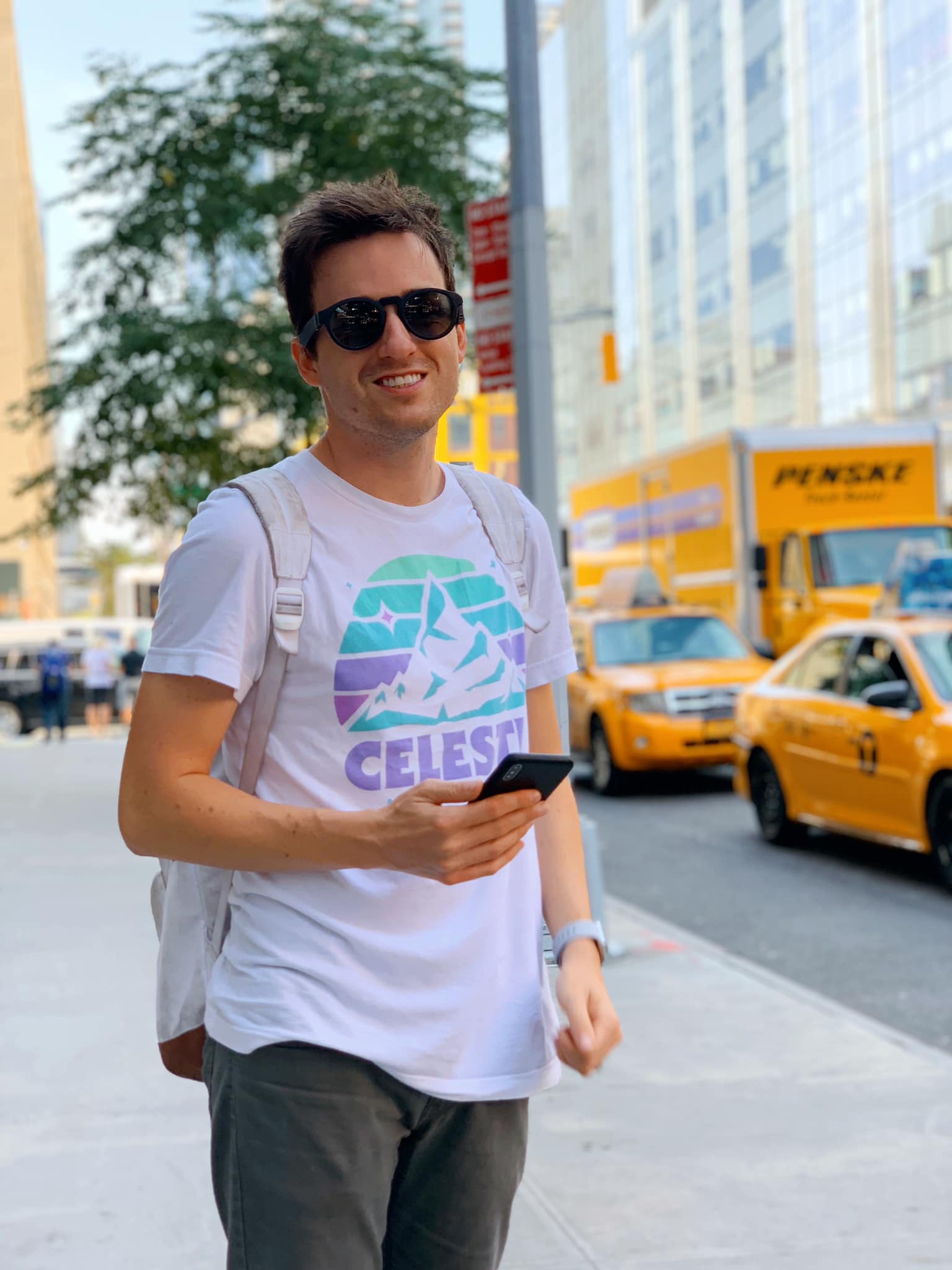 A portrait of Jordan standing on a sidewalk in New York City.